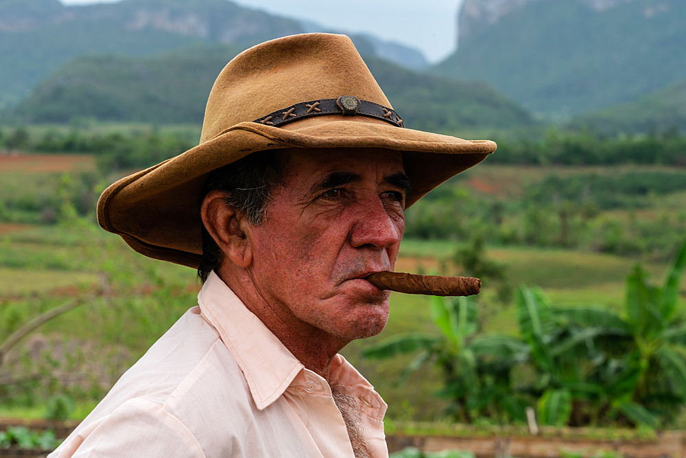 Tobacco plantation worker with cigar, on valley ridge, Vinales, Cuba 2 (Model Release)