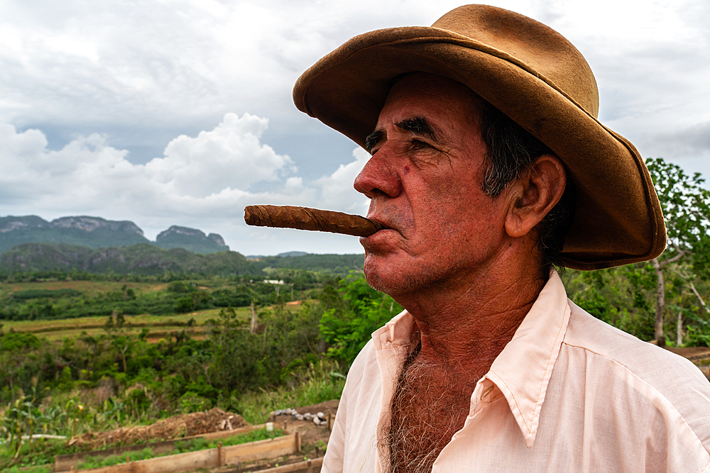 Tobacco plantation worker with cigar, on valley ridge, Vinales, Cuba 3 (Model Release)