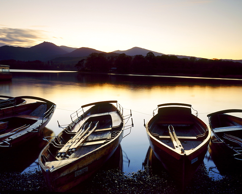 Boats moored beside Derwent Water at dusk, Lake District, Cumbria, England, UK 