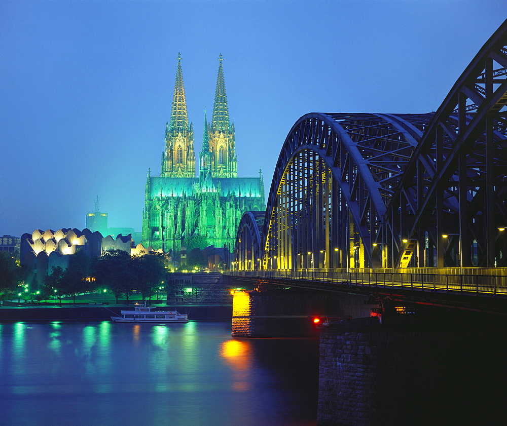 Hohenzollernbrucke and the Cathedral Illuminated at Night, Cologne, Germany