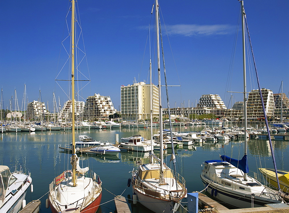 Boats in the harbour and modern buildings in the background, at La Grande Motte, Languedoc, Languedoc Roussillon, France, Europe