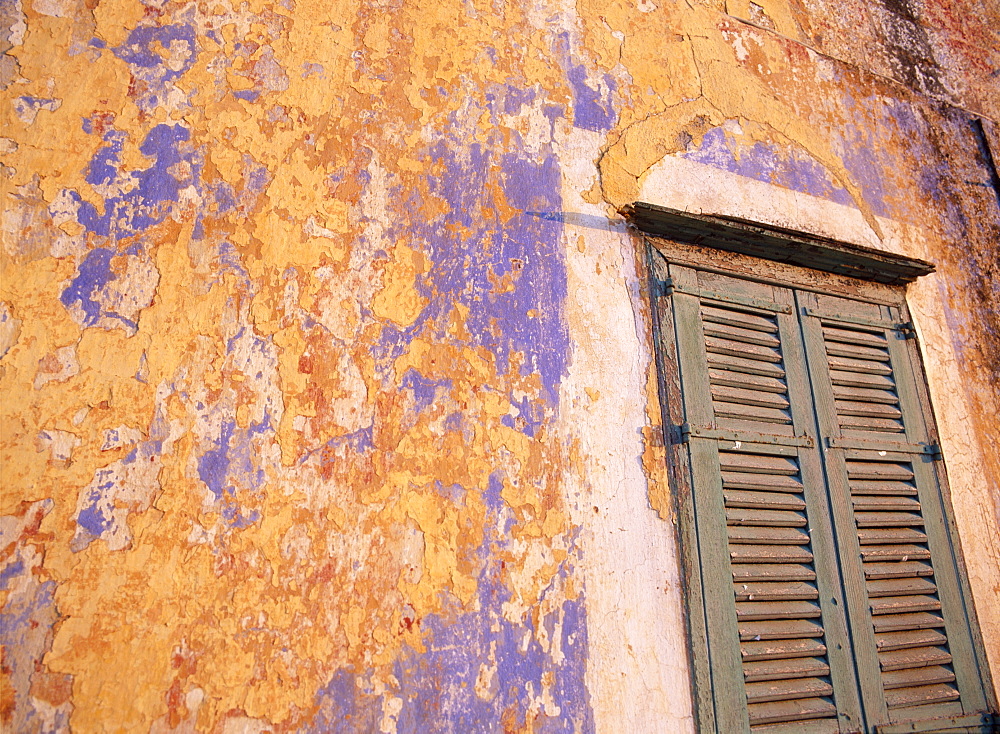 Peeling blue and ochre wall and shutters, Rhodes, Dodecanese Islands, Greece 