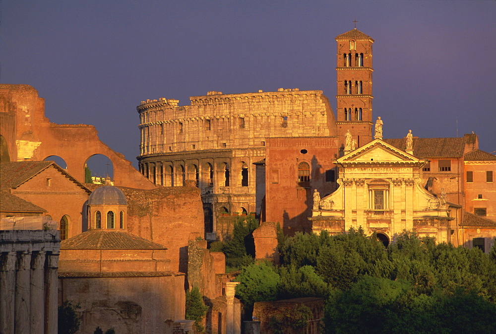 View across the Roman Forum towards Colosseum and St. Francesco Romana, Rome, Lazio, Italy, Europe