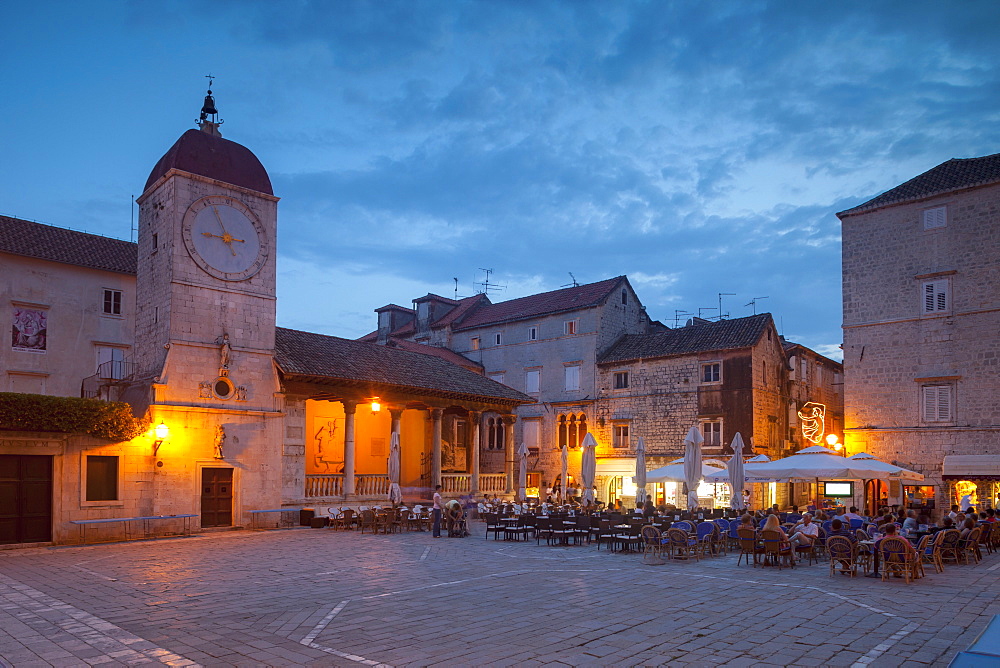 Main square lit up at dusk with cafes, Trogir, UNESCO World Heritage Site, Dalmatian Coast, Croatia, Europe 