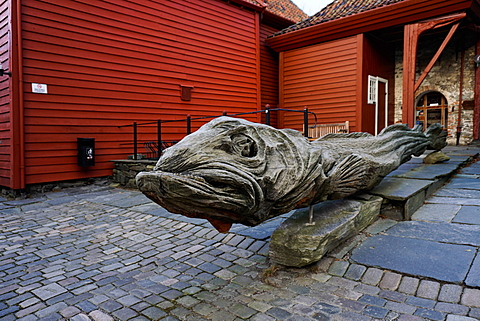 Carved wooden statue of a stock fish a type of cod, Hanseatic quarter, Bryggen, Bergen, Hordaland, Norway, Scandinavia, Europe