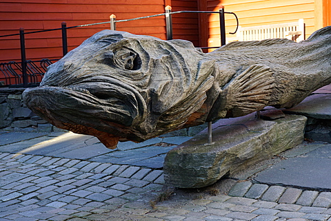 Carved wooden statue of a stock fish a type of cod, Hanseatic quarter, Bryggen, Bergen, Hordaland, Norway, Scandinavia, Europe