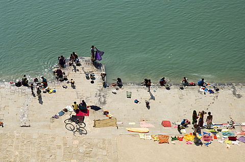 Washing at the ghats on the Narmada River at the Ahilya Fort and Temples,  Maheshwar, Madhya Pradesh, India