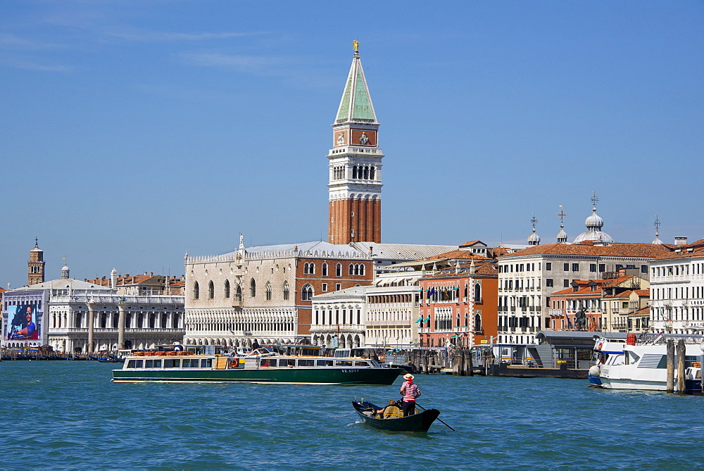 Gondola and gondolier on San Marco Basin, with Palazzo Ducale, San Marco Campanile, and Danieli Hotel in the background, Venice, UNESCO World Heritage Site, Veneto, Italy, Europe