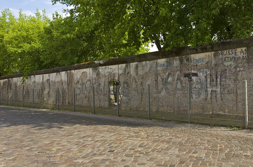 Part of the preserved section of the Berlin wall (Berliner mauer), on Zimmerstrasser near Checkpoint Charlie, Berlin, Germany, Europe