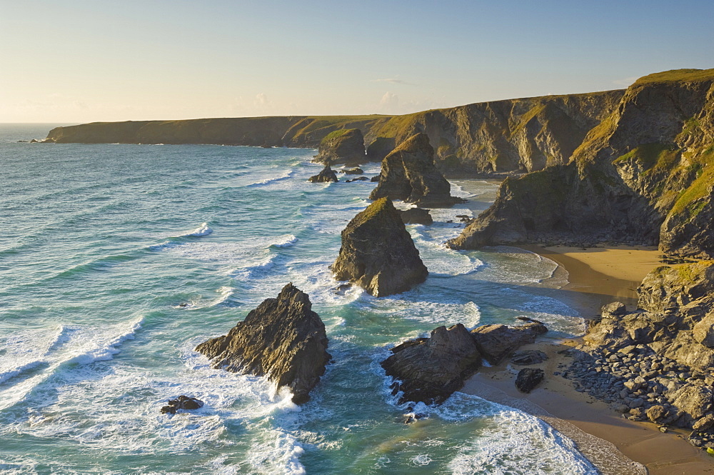 Evening light on the rock stacks, beach and rugged coastline at Bedruthan Steps, North Cornwall, England, United Kingdom, Europe