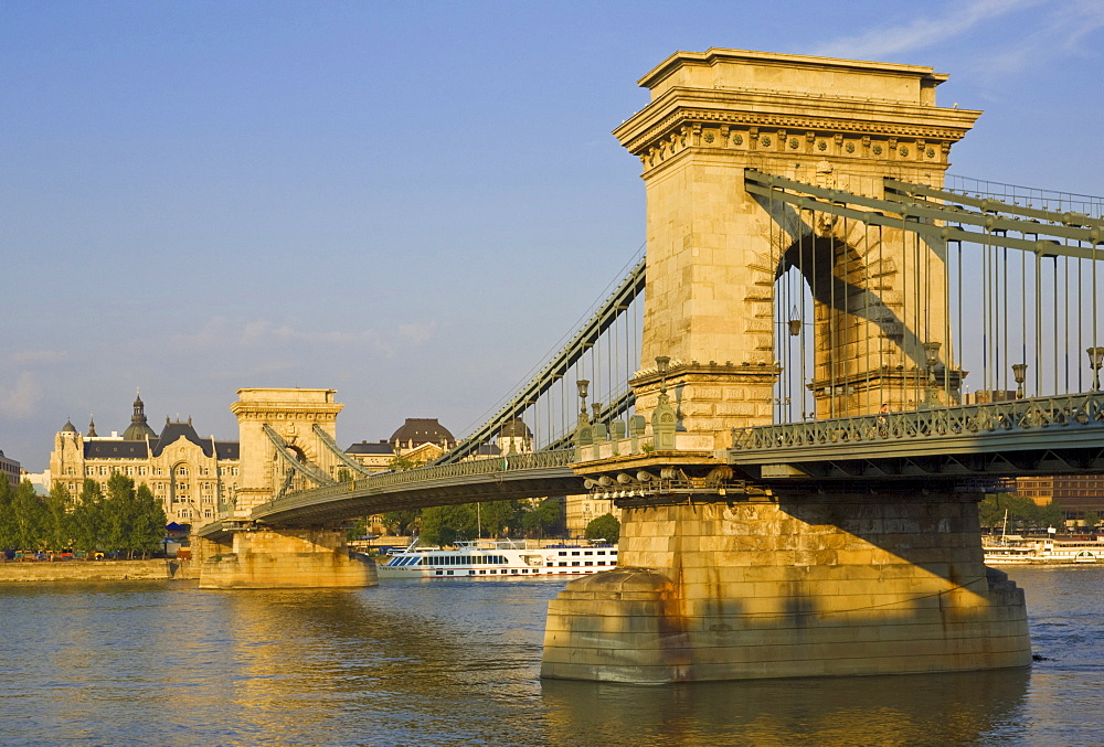 The Chain Bridge (Szechenyi Lanchid), over the River Danube with the Gresham Hotel and cruise boats behind, Budapest, Hungary, Europe