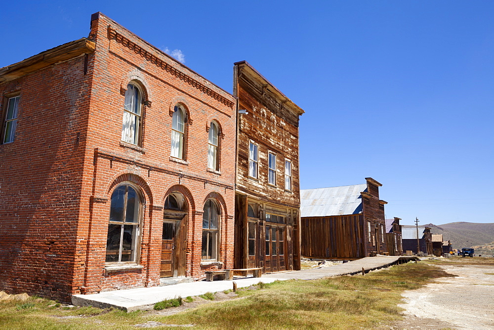 Brick Post Office and Dechambeau hotel, next to the wooden IOOF or Bodie Odd Fellows Lodge, a masonic lodge dating from 1878, on Main Street in the gold mining ghost town of Bodie, Bodie State Historic Park, Bridgeport, California, United States of America, North America