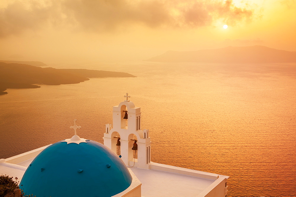 Blue dome and bell tower at sunset, St. Gerasimos church and Aegean Sea, Firostefani, Fira, Santorini (Thira), Cyclades Islands, Greek Islands, Greece, Europe