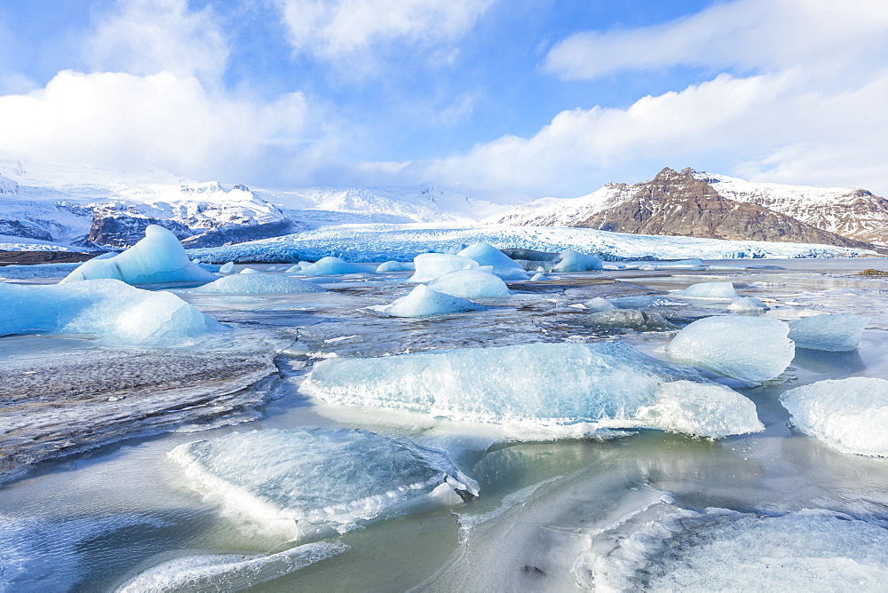 Frozen icebergs locked in the frozen waters of Fjallsarlon Glacier lagoon, South East Iceland, Iceland, Polar Regions