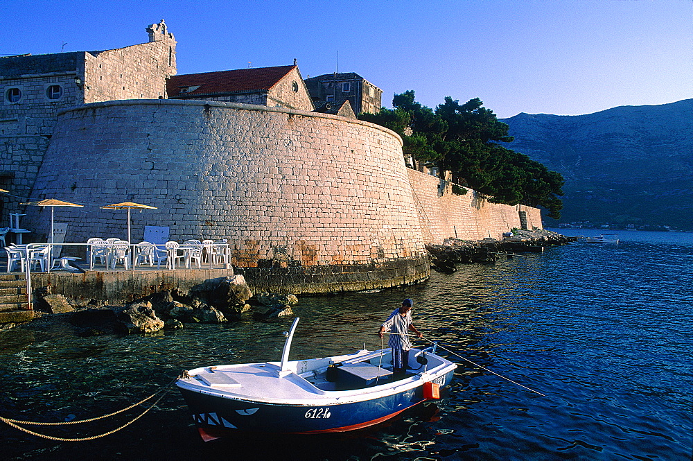 Croatia, Dalmatia, Dalmatian Coast, Kordula Island, The Fortified City Ramparts At Dusk, Fisherman Leaving At Fore