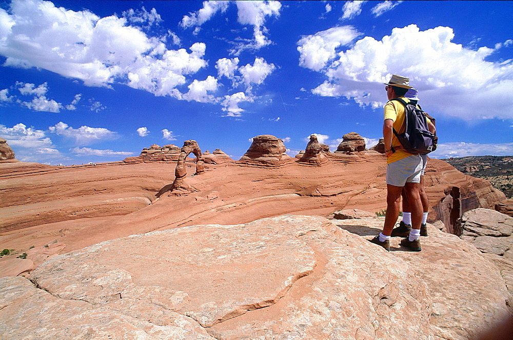 Usa, South West, Utah, Arches National Park, Hikers Looking At Elegant Arch 