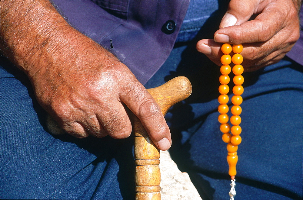 Syria, Limestone Region West Of Aleppo, Abandoned Village, In Saint Simeon, The Warden Holds A Stick And An Islamic Rosary Sbih To Help Repeat Prayers