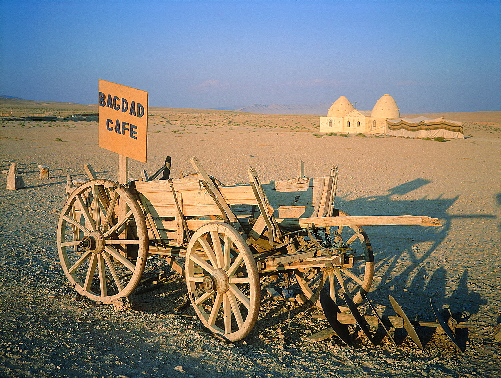 Syria, East Desert Or Steppe, Mosque In Background, At Fore An Old Cart Indicating The Famous Baghdad Cafe On The Road Between Damascus And Palmyra