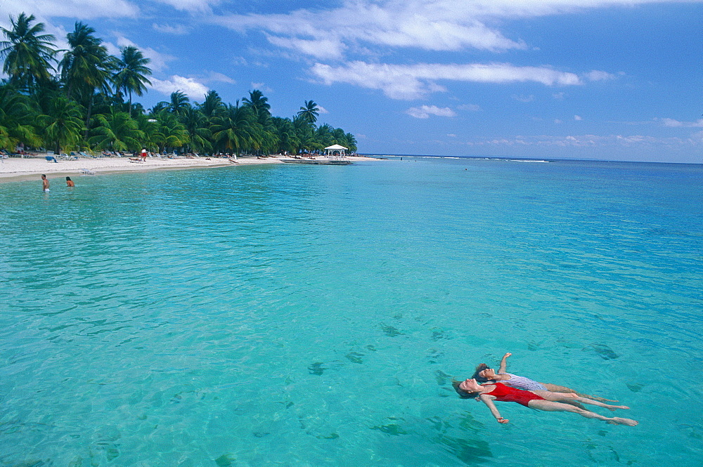 French West Indies, Guadeloupe, Gosier Beach, Woman And Child Idling On Back In Sea