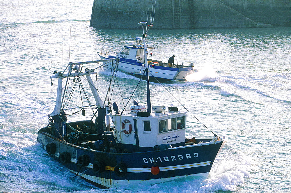 France, Normandy, Manche (50), Granville, Small Trawler Fishing Boats Leaving Or Entering The Harbour At Dusk