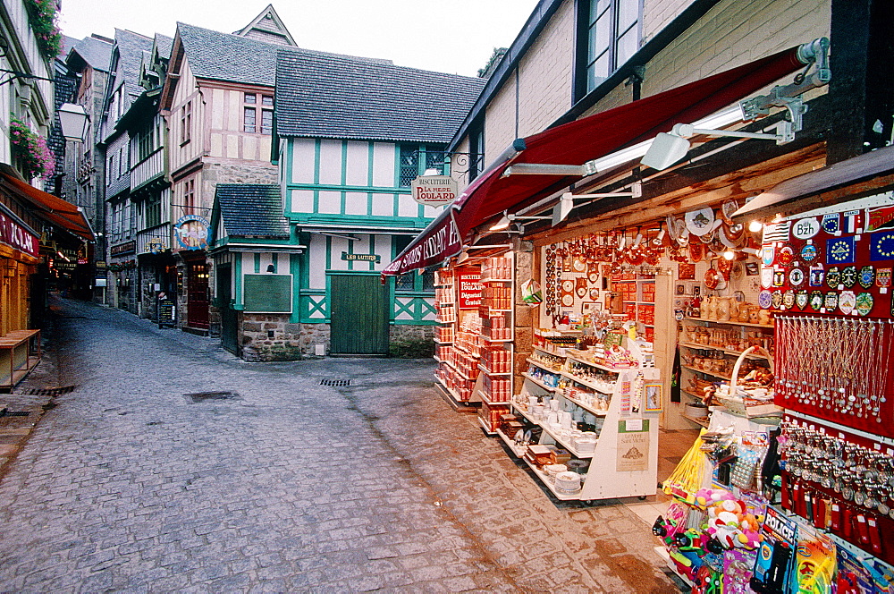 France, Normandy, Manche (50), Mont Saintmichel, The Shopkeepers Mainly Specialized In Selling Souvenirs Most Of Them Very Kitch, The Grand Rue At Dusk In Winter