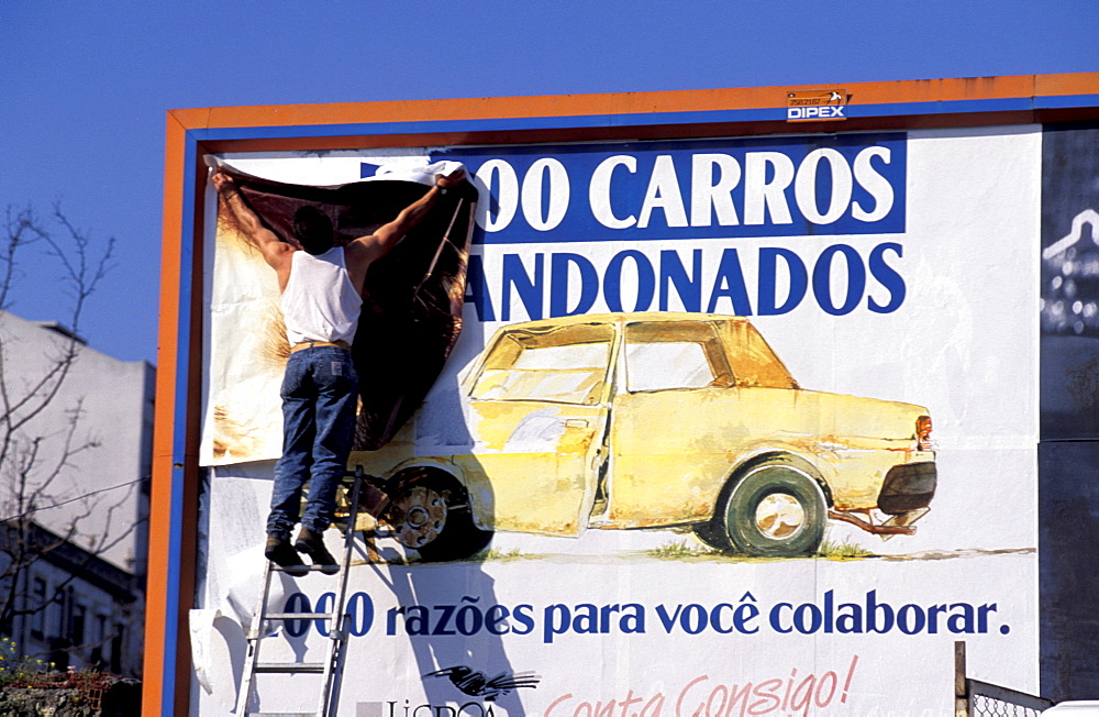 Portugal, Lisbon, The People, Man Fixing A New Ad On A Billboard