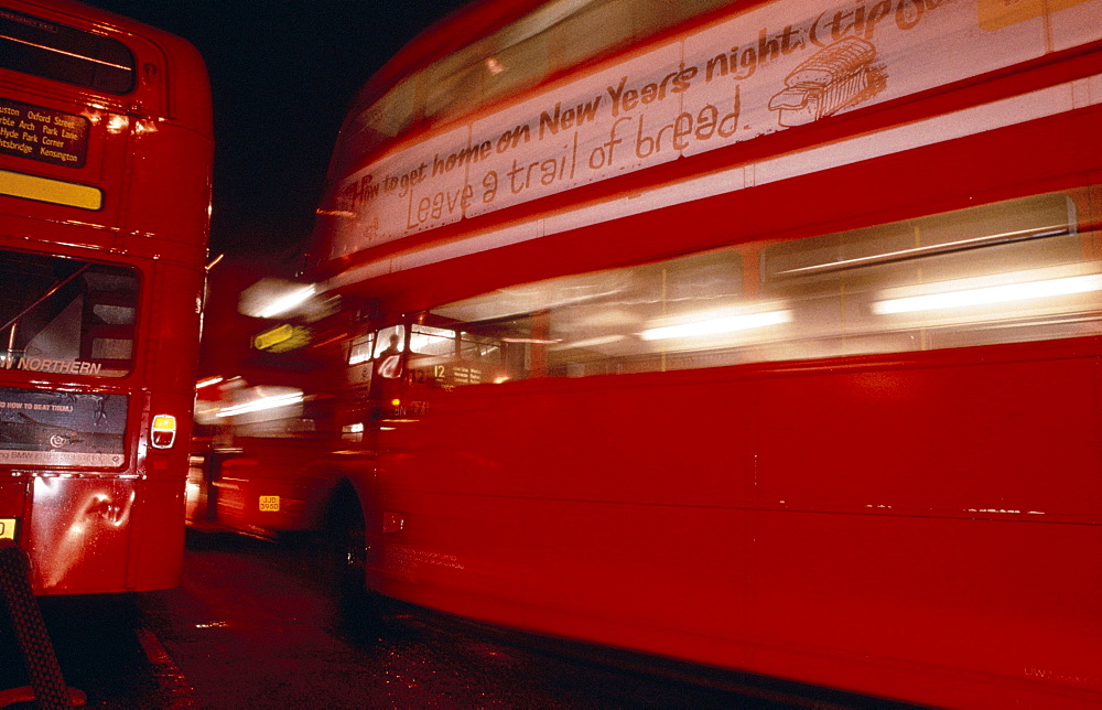 Double decker buses on Oxford Street at night, London, England, UK, Europe