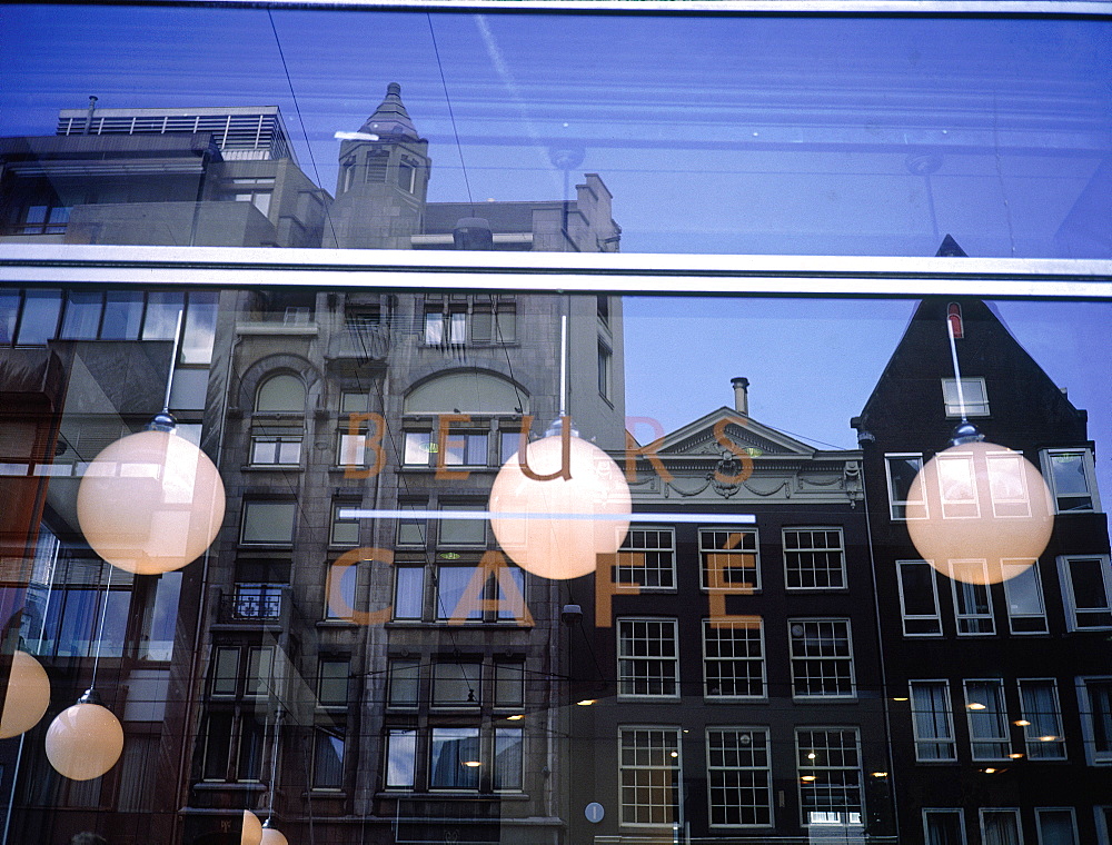 Netherlands, Amsterdam Old Flemish Houses Reflecting On A Window Of A Cafe