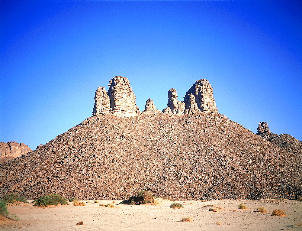 Algeria, Sahara, Tassili M'ajjer, Tikoubadouine Desert, Peaks Surrounded By Fallen Stones 