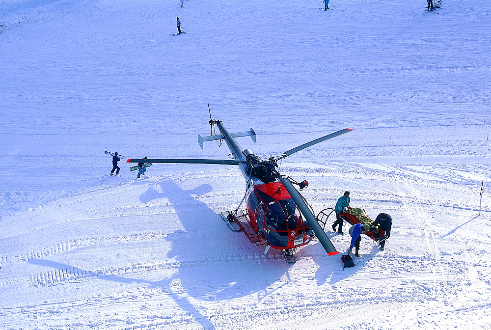 France, Alps In Winter, A Wounded Skier Being Evacuated By A Rescue Helicopter 