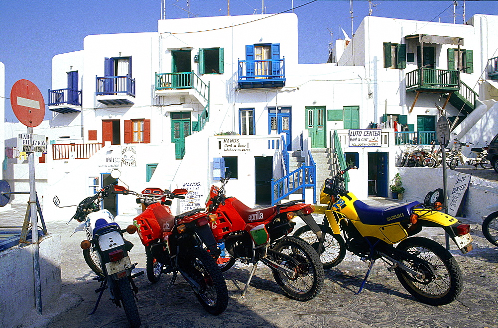 Greece, Cyclades, Mykonos Island, Small Colored Bikes To Rent For To Urists Against White Houses