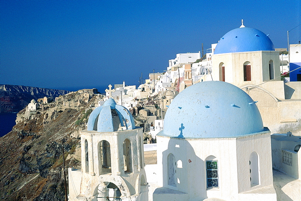 Greece, Cyclades, Santorini Island, Ia Village, Three Blue Painted Domes On A Plain Chapel