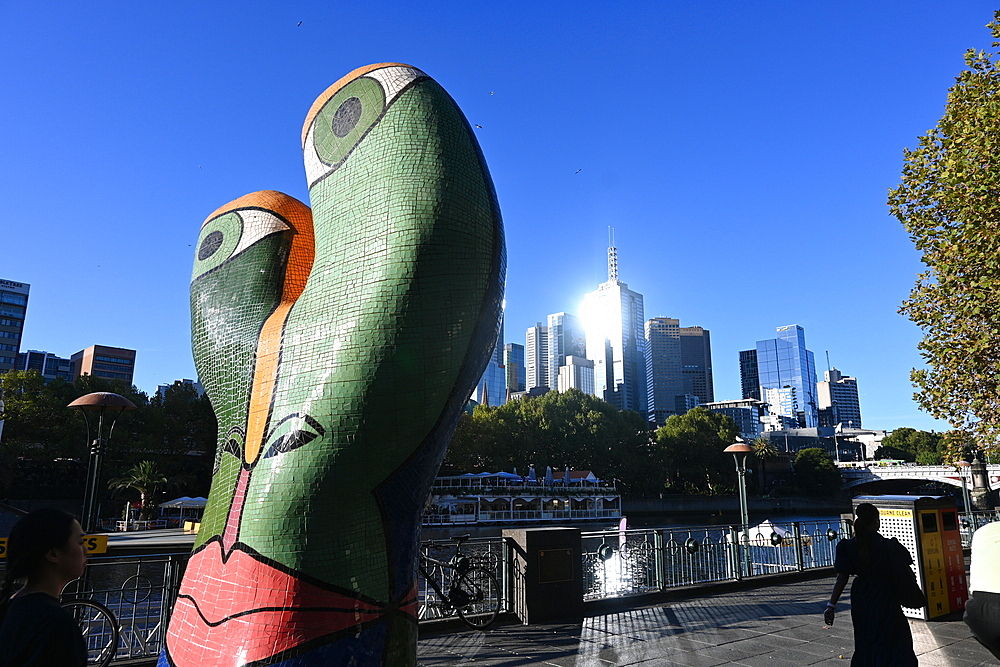 Modern sculpture and city skyline