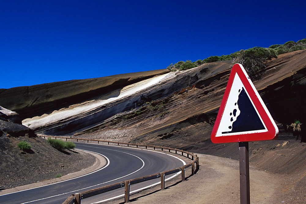 Sign on road with stratified volcanic rocks in the background, Parque Nacional del Teide, Tenerife, Canary Islands, Spain, Atlantic, Europe