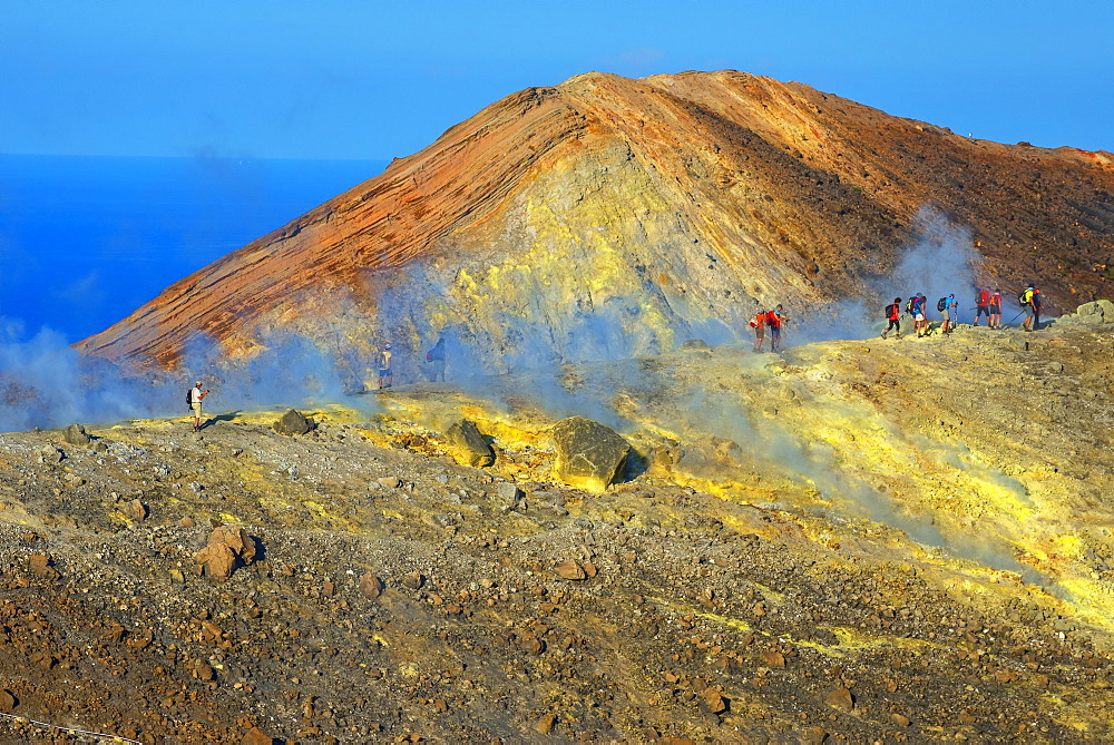 People walking through fumaroles on Volcano Gran crater rim, Vulcano Island, Aeolian Islands, UNESCO World Heritage Site, north of Sicily, Italy, Mediterranean, Europe