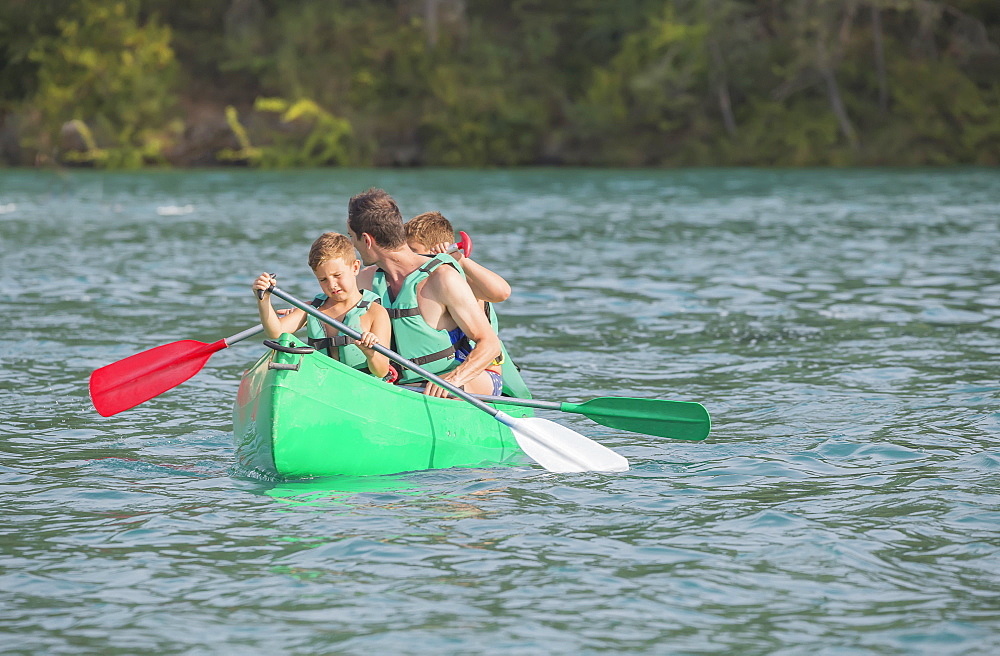 Family practising in canoe, Esparron lake, Esparron de Verdon, Alpes de Haute Provence, France, Europe