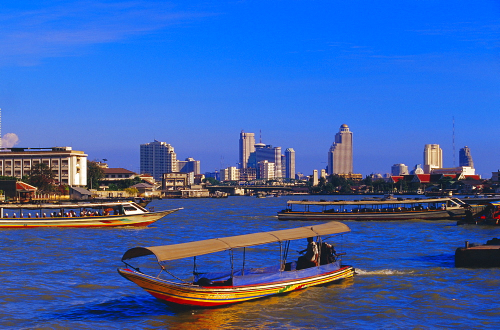 Longtail boat and city skyline, Bangkok, Thailand