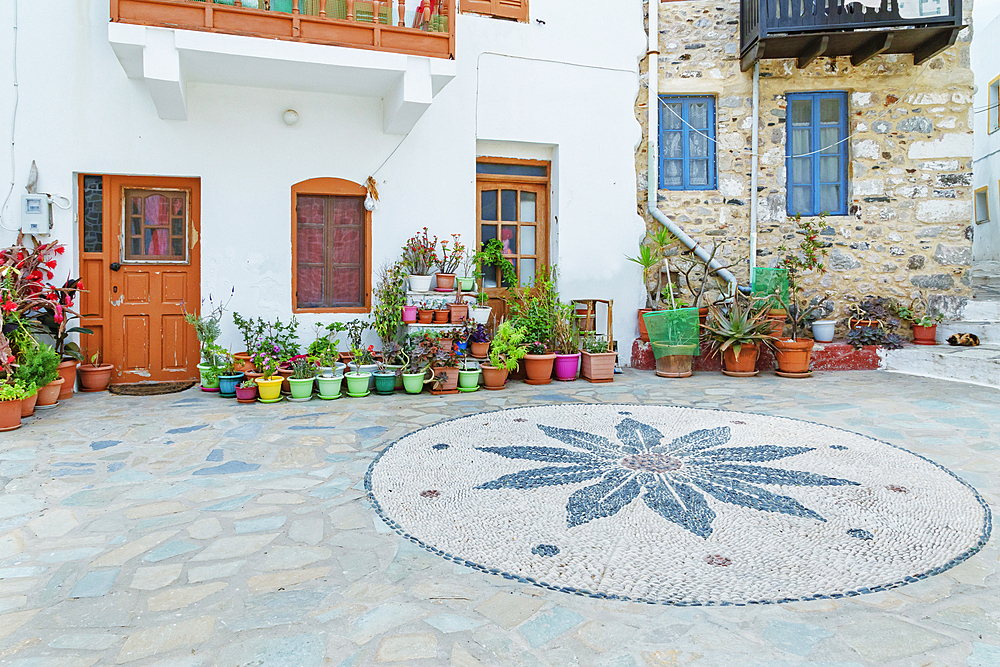 Traditional pebble mosaic adorning Mandraki old town, Mandraki, Nisyros Island, Dodecanese Islands, Greece