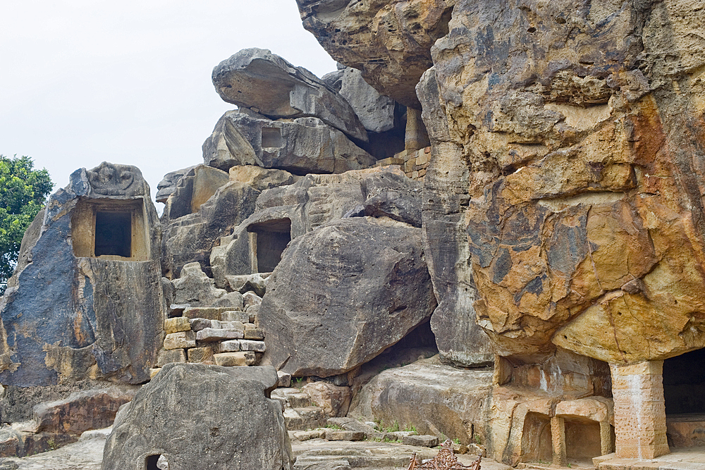 Monks' cells cut into the hillside rock among the Udayagiri and Khandagiri caves dating back to over 100 years BCE sculpted as religious retreats for Jain devotees, Bhubaneswar, Odisha, India, Asia