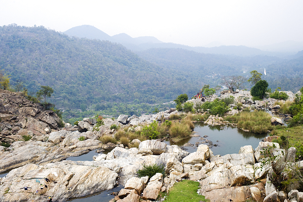 Local tribal women gather near the 322 feet Hundru waterfall to feast Shiva, the Supreme being in Hindu Shaivism, and beseech health and strength for their menfolk, Ranchi, Jharkhand, India, Asia