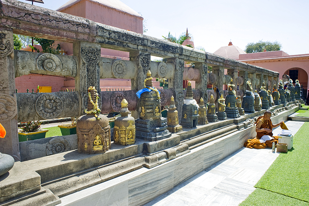 Antique votive stupas line the Chankramana Walk adjacent to the ancient north wall of the Buddhist Mahabodhi Mahabihara Temple (Great Stupa), Bodh Gaya, UNESCO World Heritage Site, Bihar, India, Asia