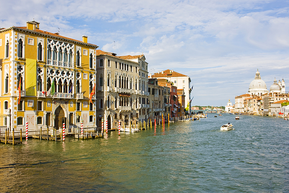 A view of the Grand Canal opening out into the lagoon seen from the Ponte de l'Accademia with Palazzo Franchetti (Palazzo Cavalli-Franchetti) on the left, and Basilica of Santa Maria de la Salute in the background, Venice, UNESCO World Heritage Site, Veneto, Italy, Europe