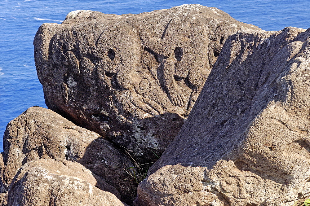 Petroglyphs with birdman images beside the lake in a crater at Orongo, Easter Island, Chile, South America