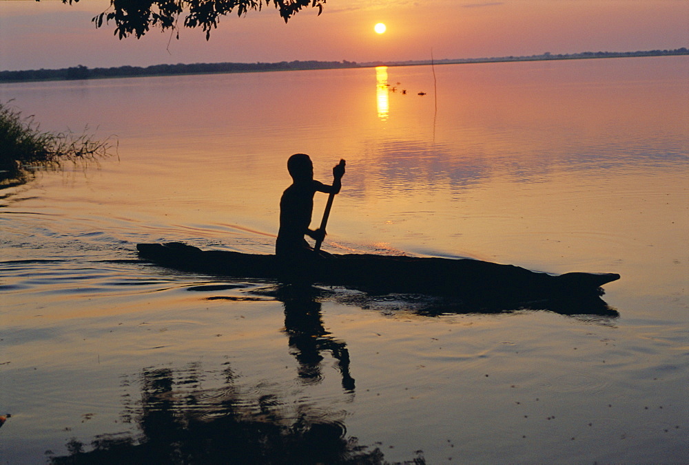 Anouak man in canoe, Lake Tata, Ethiopia, Africa 