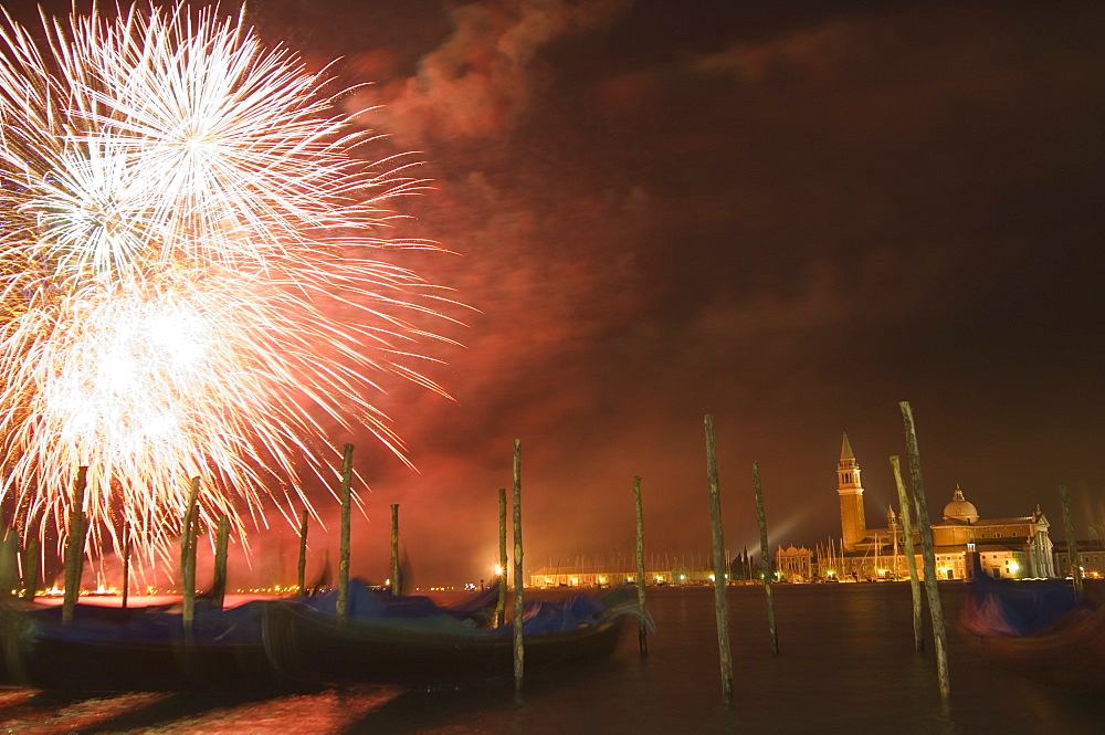 Carnival fireworks, gondolas on waterfront at night, San Giorgio Maggiore, Venice, UNESCO World Heritage Site, Veneto, Italy, Europe