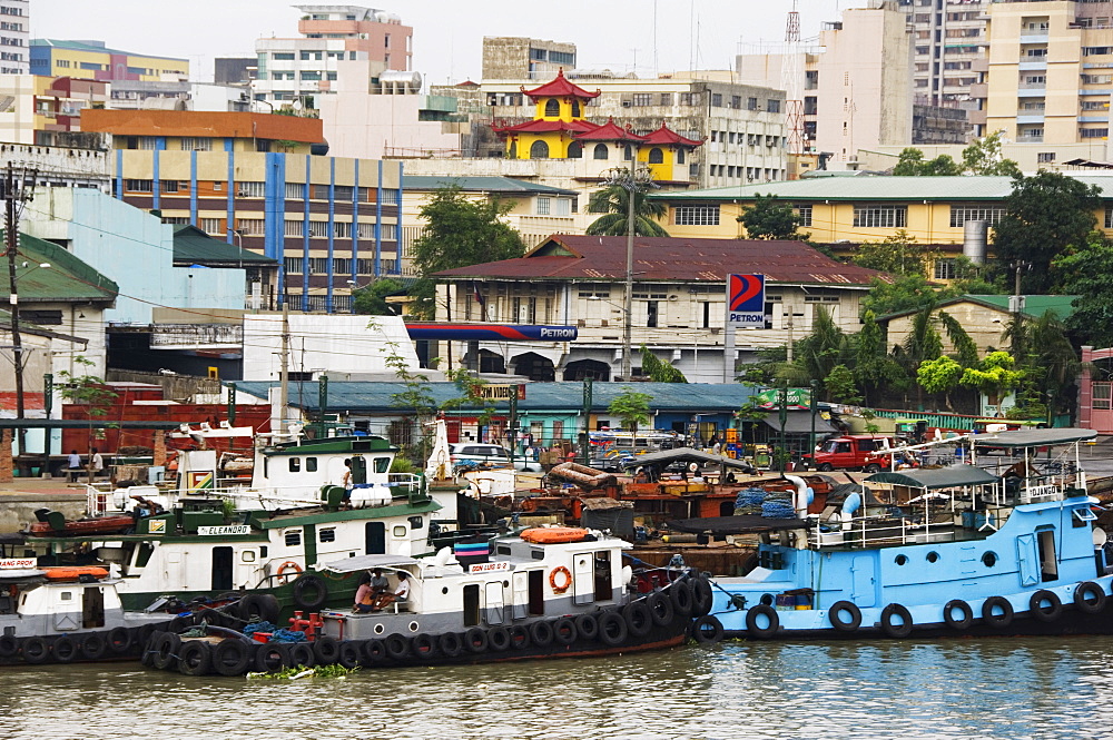 Barges on River Pasig with city buildings behind, Manila, Philippines, Southeast Asia, Asia