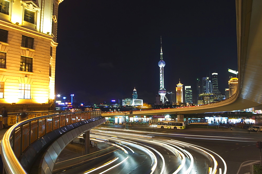 Car light trails on the Bund and The Oriental Pearl Tower illuminated in Pudong new area, Shanghai, China, Asia