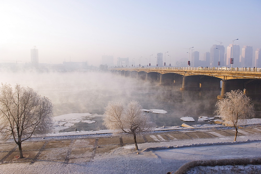 Mist rising off Songhua River and ice covered trees in winter, Jilin City, Jilin Province, Northeast China, China, Asia