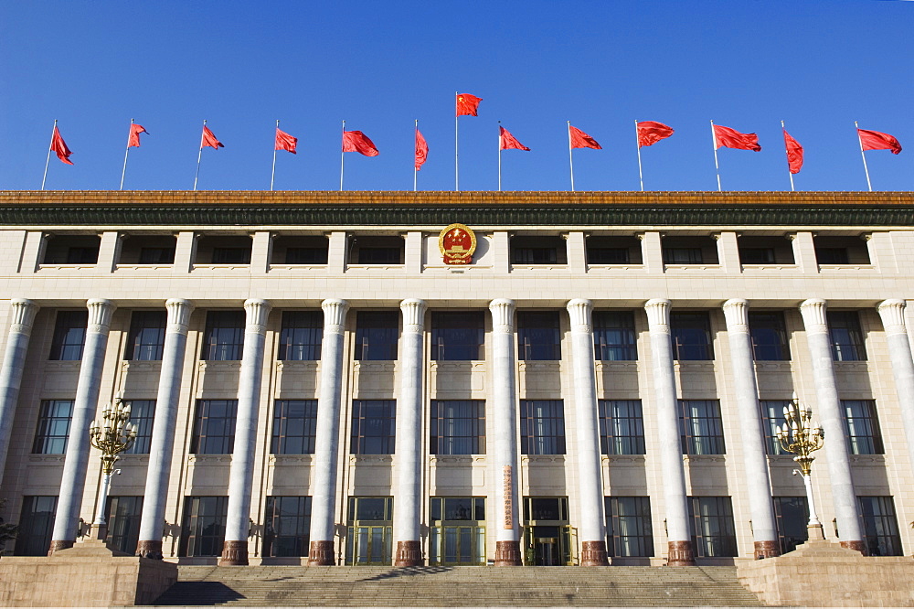 Chinese national flags on a government building Tiananmen Square Beijing China