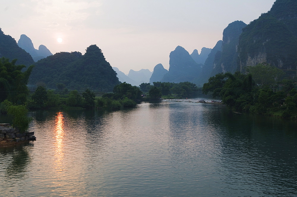 Sunset over karst limestone scenery on the Li river (Lijiang) in Yangshuo, near Guilin, Guangxi Province, China, Asia